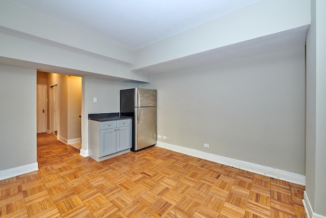 kitchen with light parquet flooring and stainless steel fridge