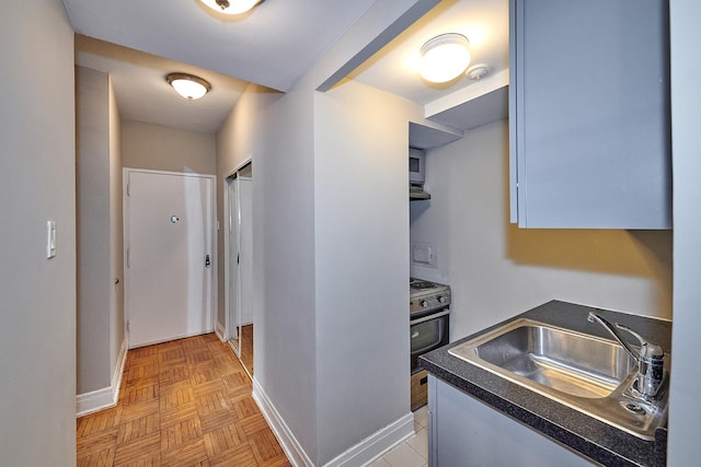 corridor featuring sink and light parquet floors