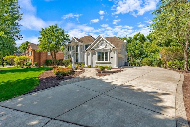 view of front facade with a garage and a front lawn