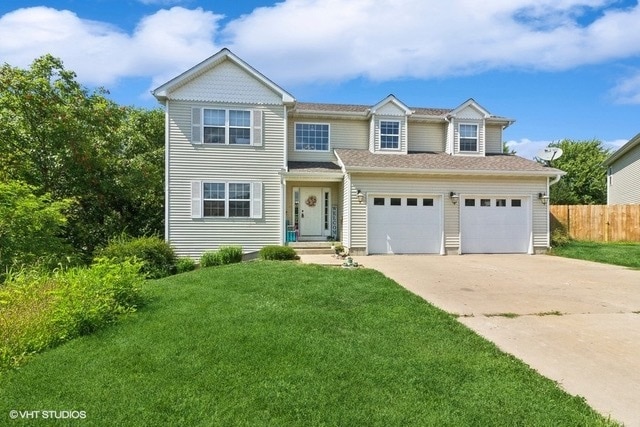 view of front of home featuring a garage and a front yard