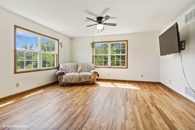 sitting room with ceiling fan, light hardwood / wood-style flooring, and a wealth of natural light