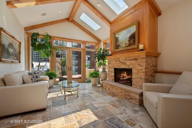 living room with stone tile floors, beamed ceiling, a stone fireplace, french doors, and high vaulted ceiling