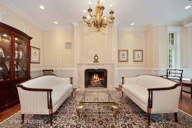 sitting room featuring parquet flooring, a notable chandelier, crown molding, and a premium fireplace