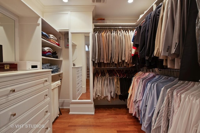 walk in closet featuring light wood-style flooring and visible vents