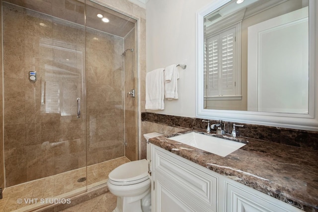 full bathroom featuring a stall shower, vanity, toilet, and tile walls