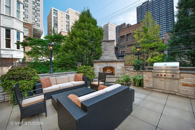 view of patio featuring a view of city, an outdoor living space with a fireplace, and area for grilling