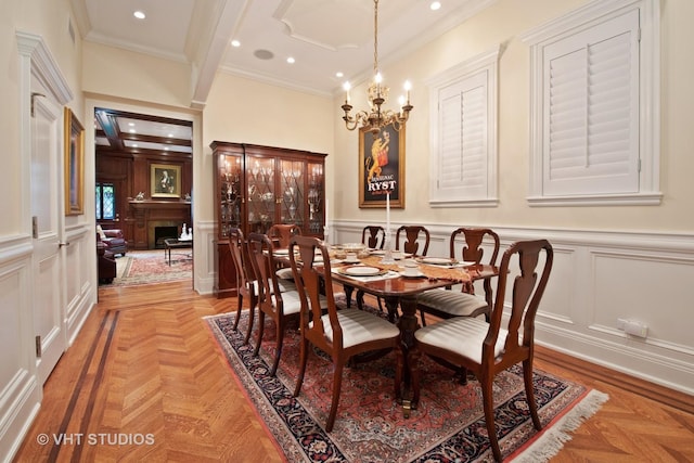 dining space featuring a chandelier, ornamental molding, recessed lighting, and a decorative wall