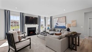 1376 Keller St, Elburn, IL 60119 - living area featuring a lit fireplace and light wood-type flooring