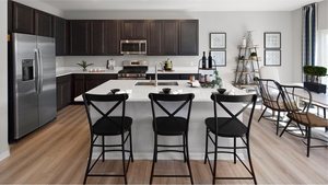 1376 Keller St, Elburn, IL 60119 - kitchen featuring stainless steel appliances, a sink, a kitchen bar, and light countertops