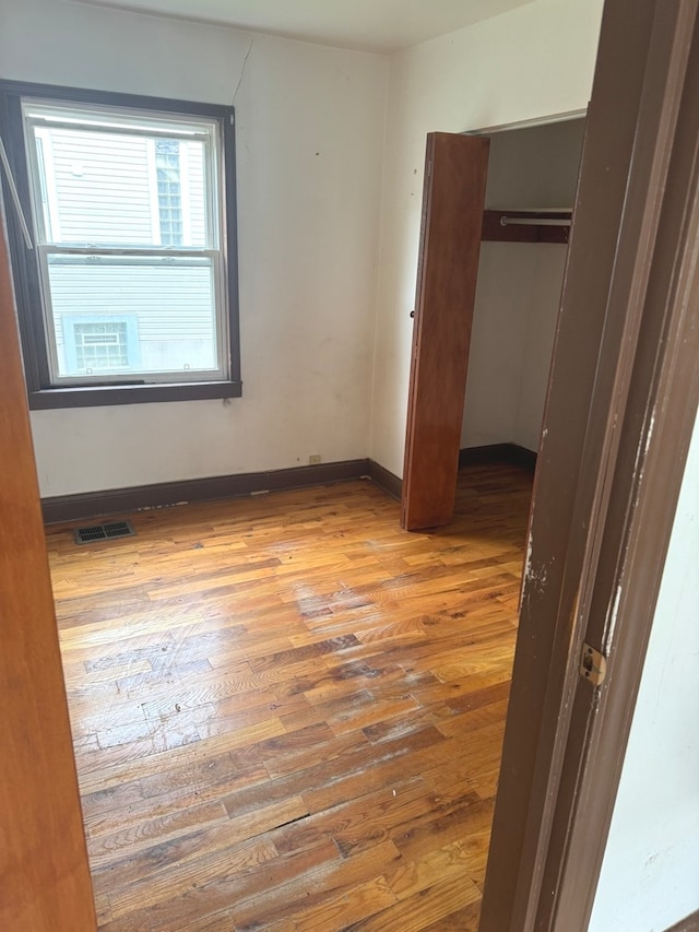 unfurnished bedroom featuring hardwood / wood-style floors