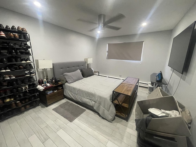 bedroom featuring light wood finished floors, a baseboard radiator, ceiling fan, and recessed lighting