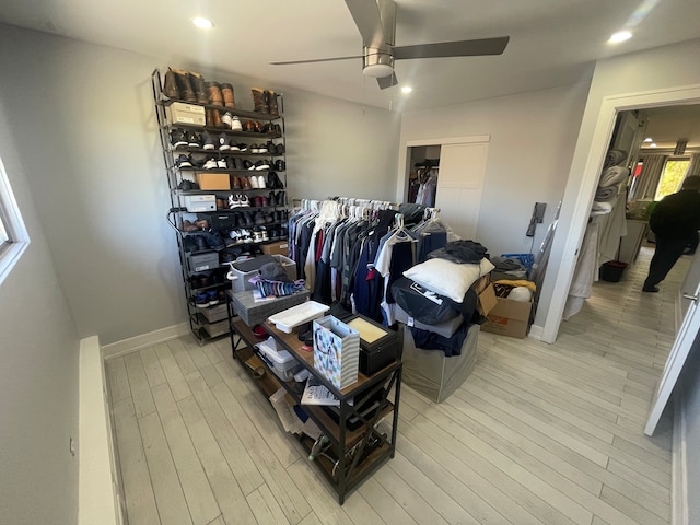 bedroom with light hardwood / wood-style floors, ceiling fan, and a closet