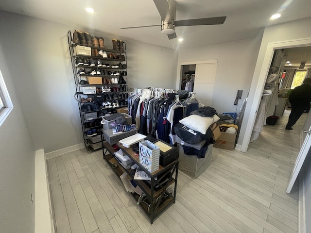 spacious closet with a ceiling fan and wood finished floors