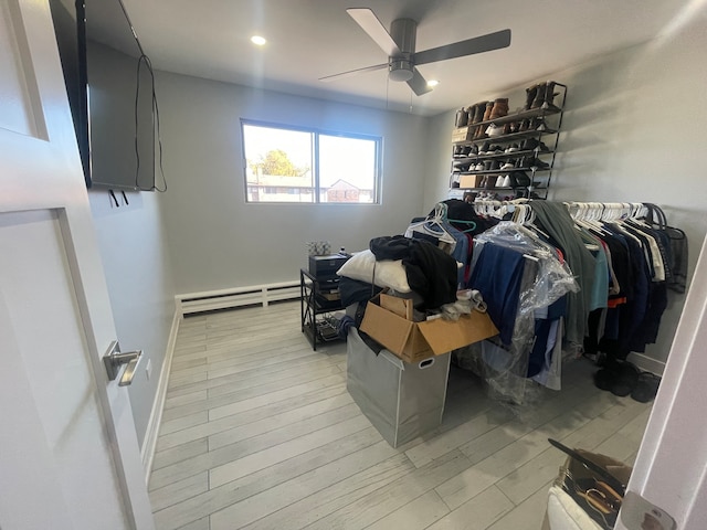 interior space with a baseboard radiator, ceiling fan, and light hardwood / wood-style flooring