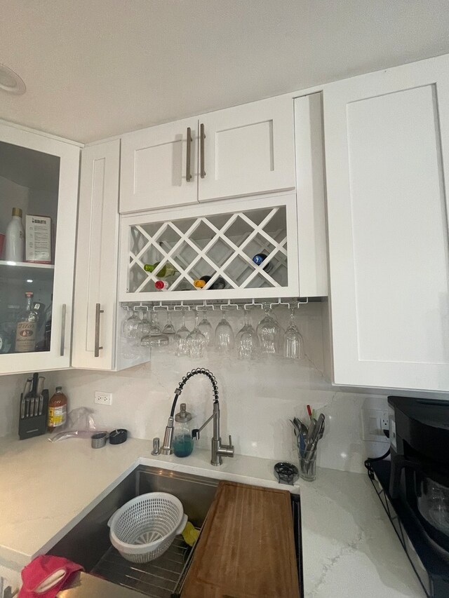 kitchen with white cabinets and decorative backsplash