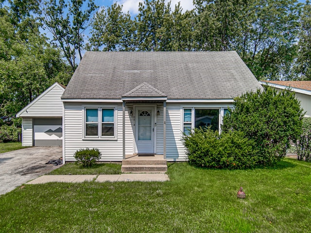 view of front of property with a garage and a front yard