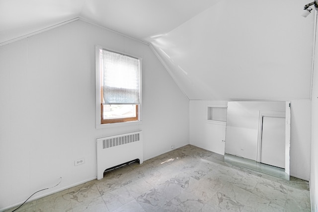 bonus room featuring radiator heating unit and vaulted ceiling