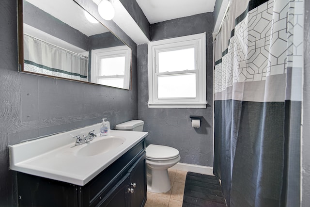 bathroom featuring vanity, tile patterned flooring, and toilet