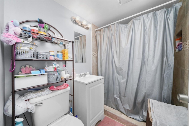 bathroom with toilet, vanity, and a shower with shower curtain