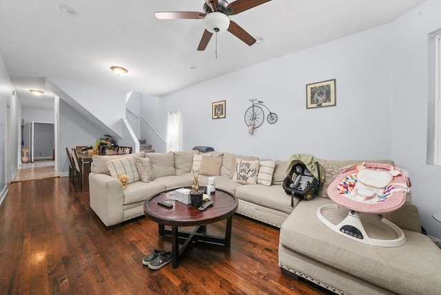 living room featuring dark wood-type flooring and ceiling fan