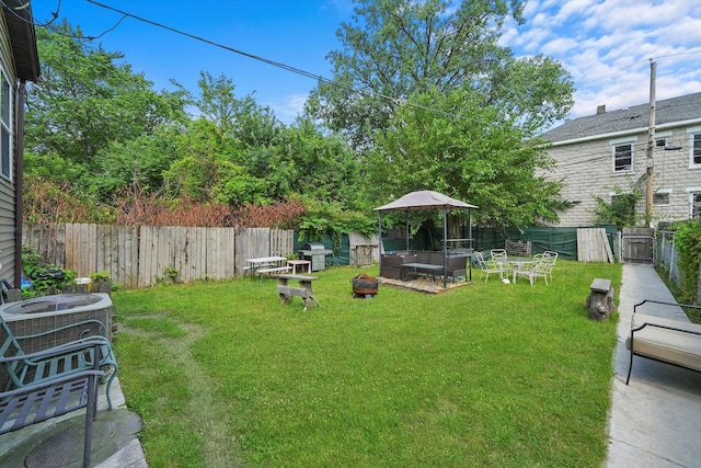 view of yard with a gazebo, central AC, and an outdoor living space with a fire pit