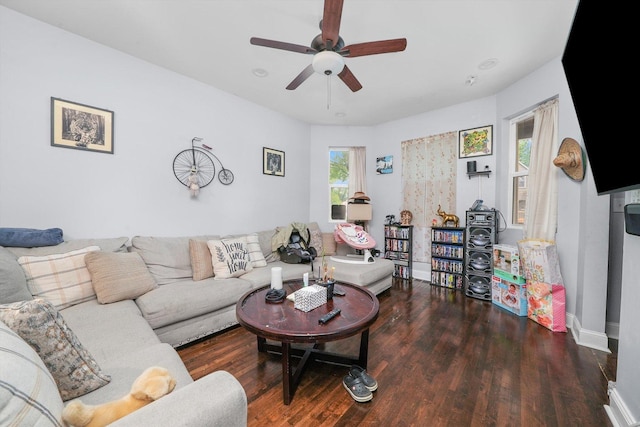 living room with ceiling fan and dark hardwood / wood-style floors