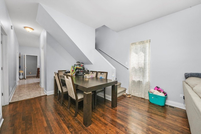 dining space with dark wood-type flooring