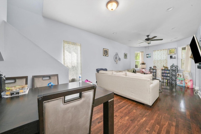 living room featuring dark hardwood / wood-style floors and ceiling fan