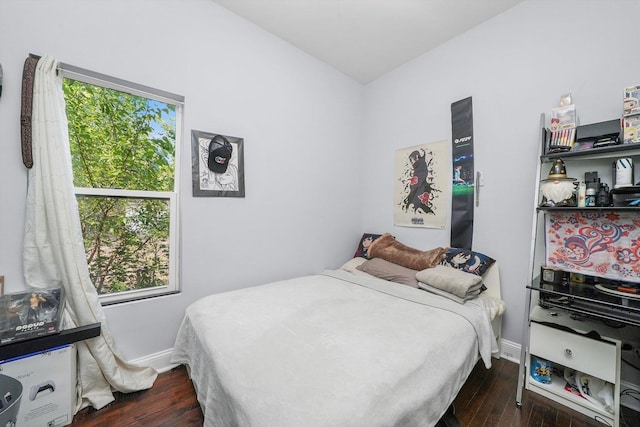 bedroom with dark wood-type flooring