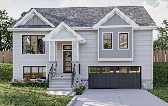 raised ranch with a garage and a front yard