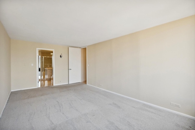 carpeted empty room with baseboards