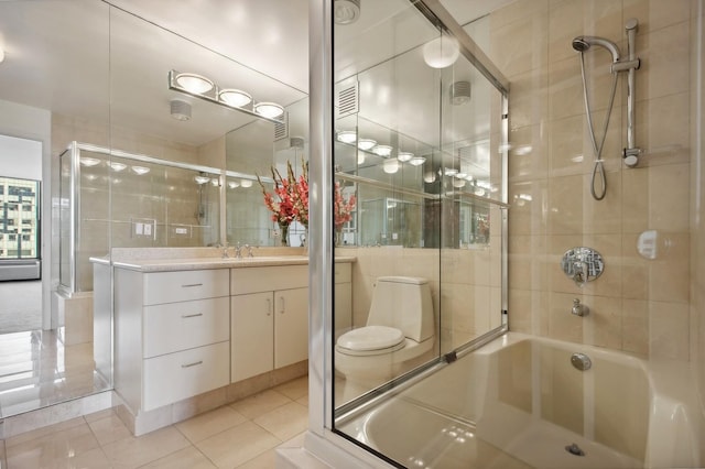 bathroom featuring vanity, visible vents, combined bath / shower with glass door, and tile patterned floors