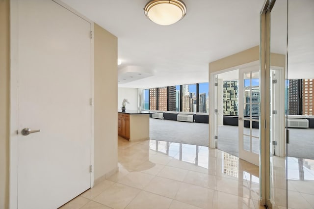 corridor with a view of city and light tile patterned floors