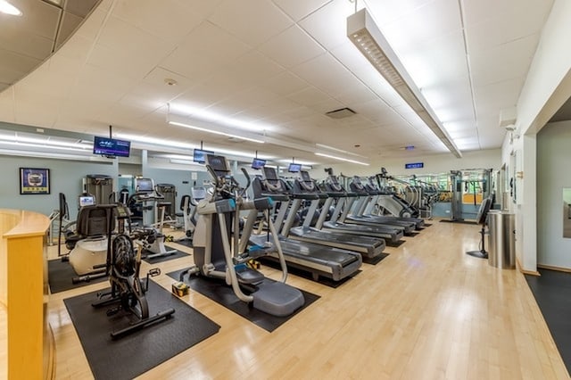 workout area with light hardwood / wood-style floors