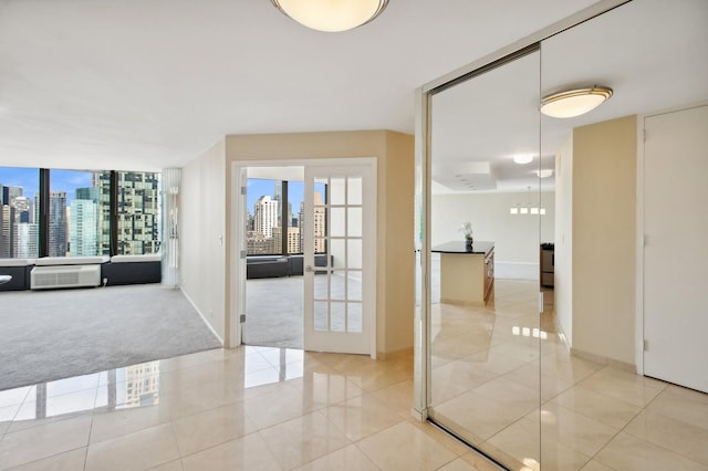 hallway featuring a view of city, french doors, light carpet, light tile patterned flooring, and baseboards