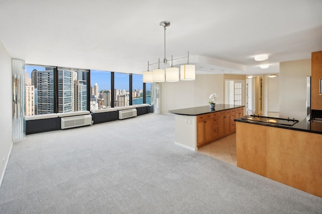 kitchen with open floor plan, a city view, dark countertops, and light colored carpet