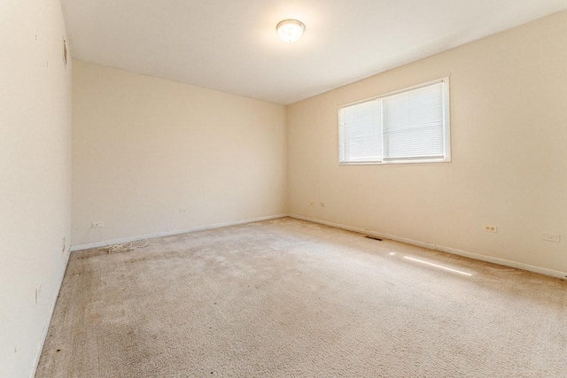 spare room with carpet flooring and baseboards