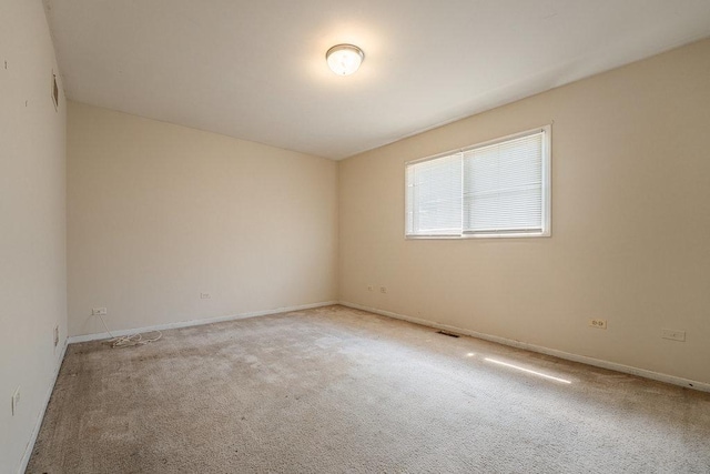 carpeted spare room with baseboards