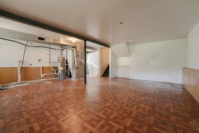 interior space featuring heating unit, stairs, and water heater