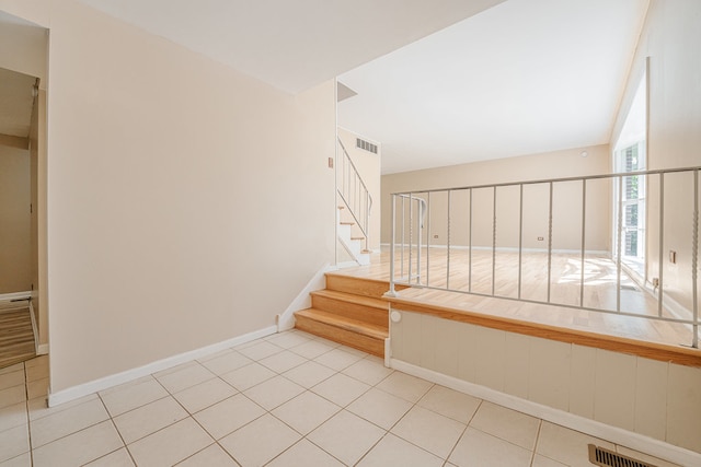 stairs featuring tile patterned flooring