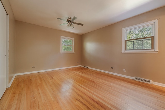 spare room featuring light hardwood / wood-style flooring and ceiling fan