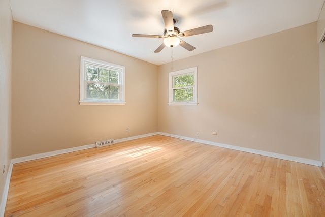 spare room featuring ceiling fan and light hardwood / wood-style flooring