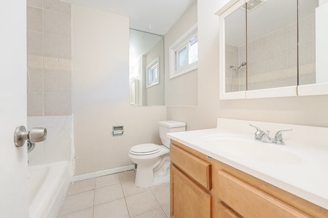 full bathroom featuring tile patterned flooring, toilet, tiled shower / bath combo, and vanity