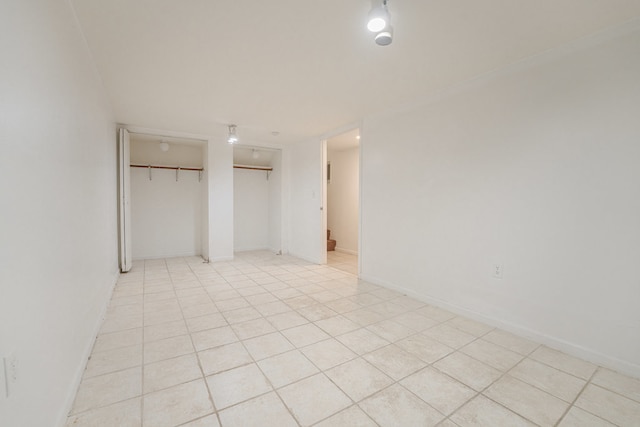 unfurnished bedroom featuring a closet and light tile patterned floors