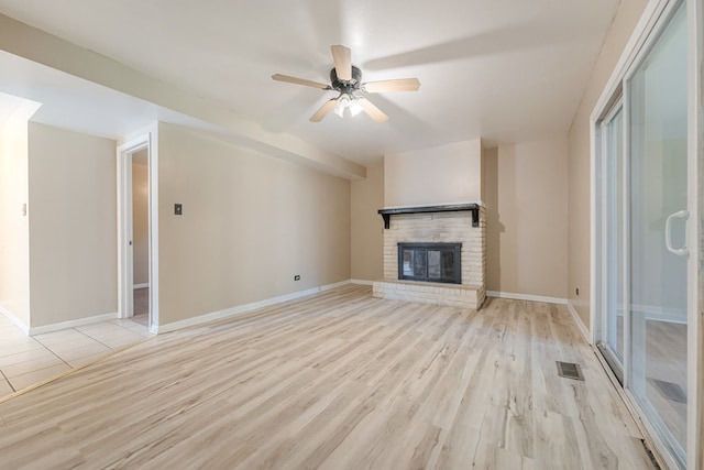 unfurnished living room with ceiling fan, light hardwood / wood-style flooring, and a fireplace