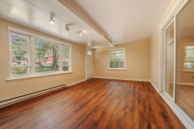 interior space featuring a baseboard radiator, dark hardwood / wood-style floors, beamed ceiling, and a healthy amount of sunlight