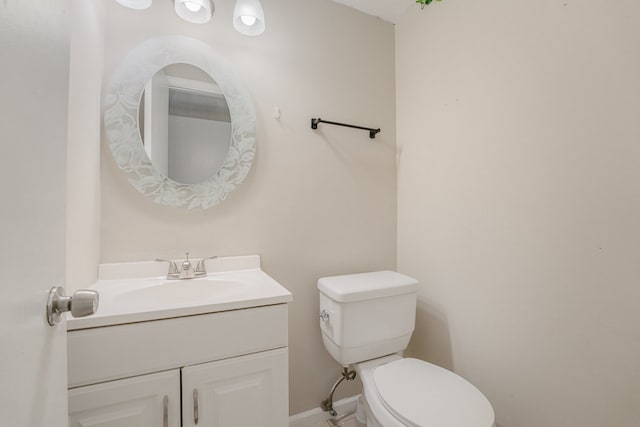 bathroom featuring toilet and vanity