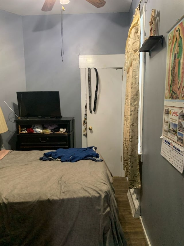 bedroom with ceiling fan and wood-type flooring