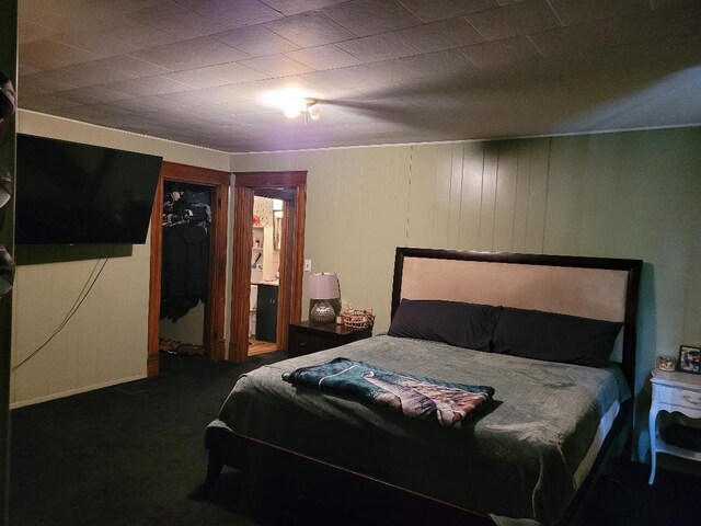 bedroom with a closet, carpet, and ensuite bathroom