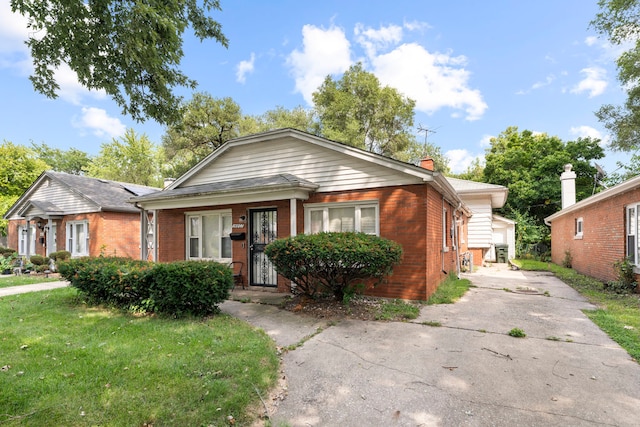 bungalow-style house with a front yard